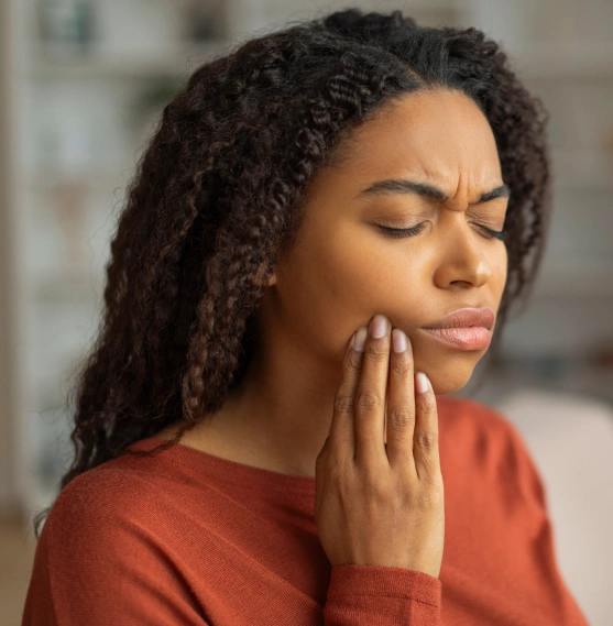Woman holding her jaw in pain