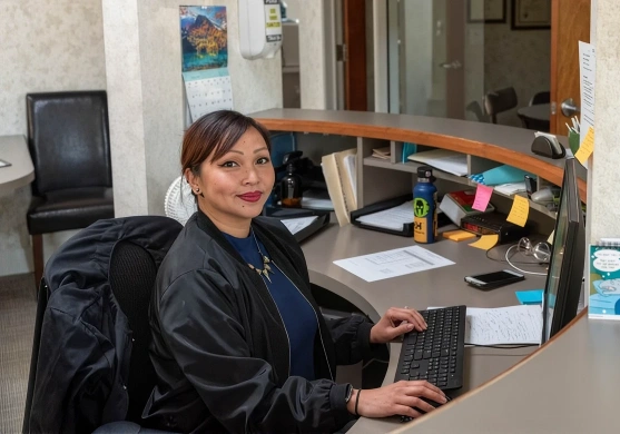 Office staff sitting and using a computer at Broadway Dental of Millbrae