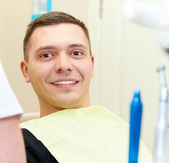 Man smiling while being treated at Broadway Dental of Millbrae