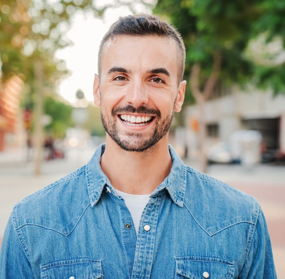 A young man smiling after treatment at Broadway Dental of Millbrae